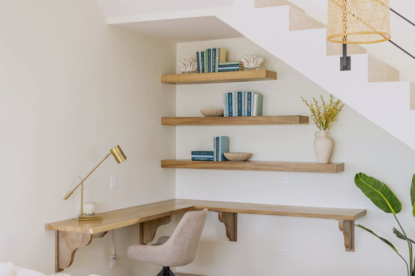 A built-in desk with shelves beside the stair, one of two work desks with wired internet