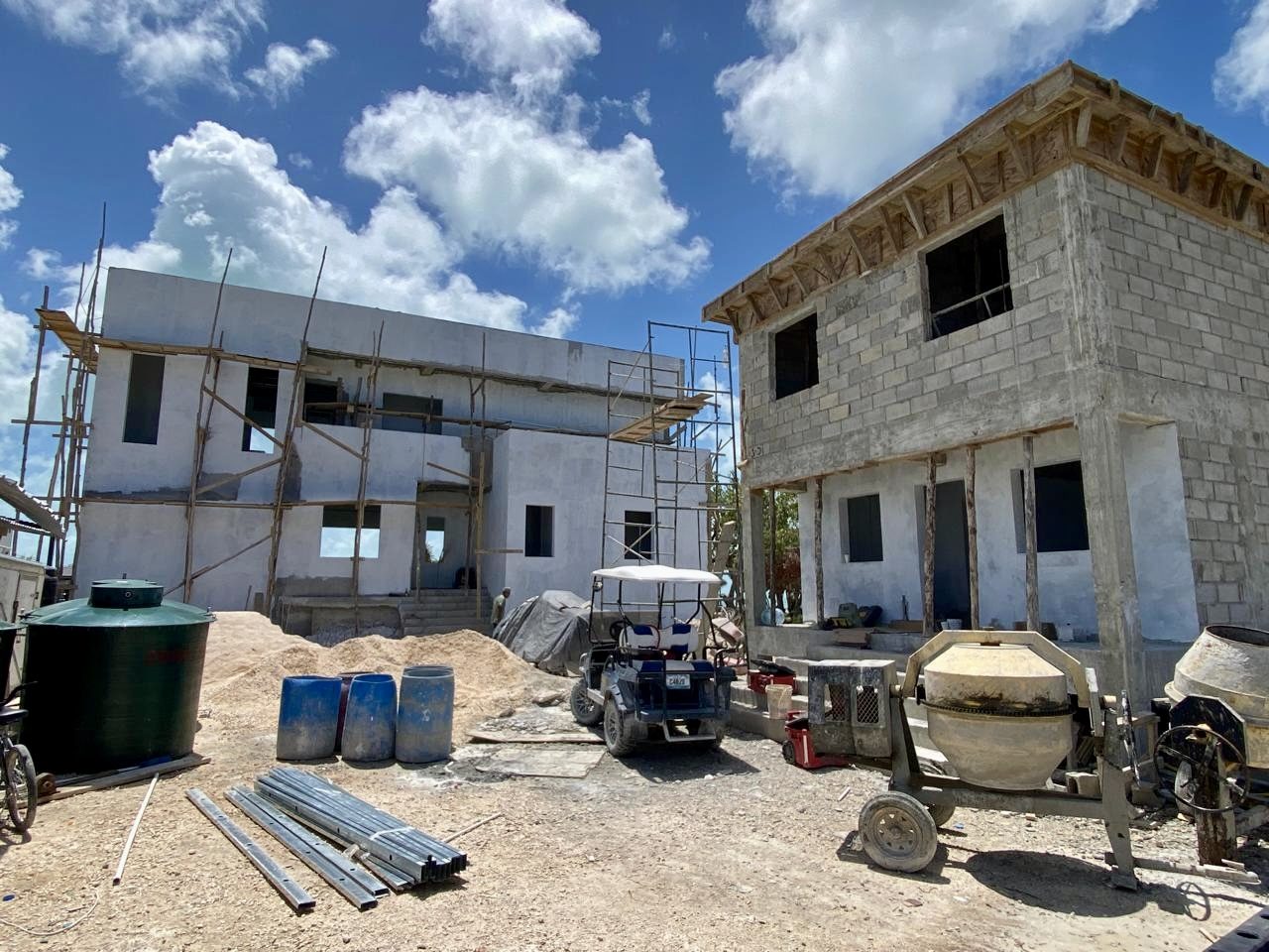 The two-story reinforced-concrete shell of Black Orchid Oasis under construction on the leeward shore of Ambergris Caye