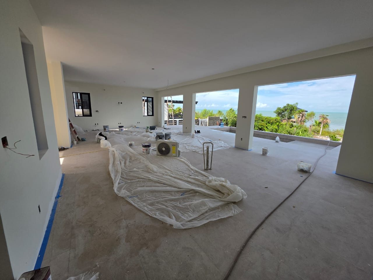 The living room during construction, open to the sea with concrete floors poured