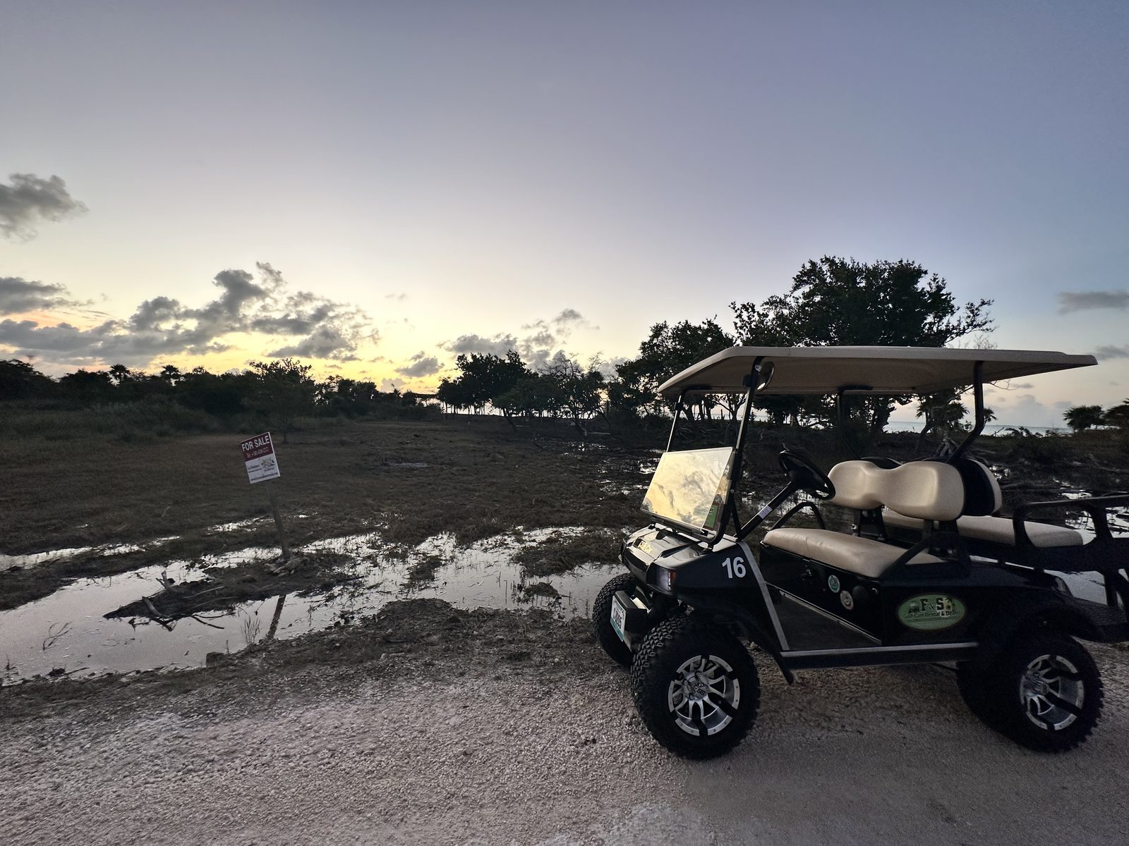 An early site walk by golf cart across the low beachfront lot